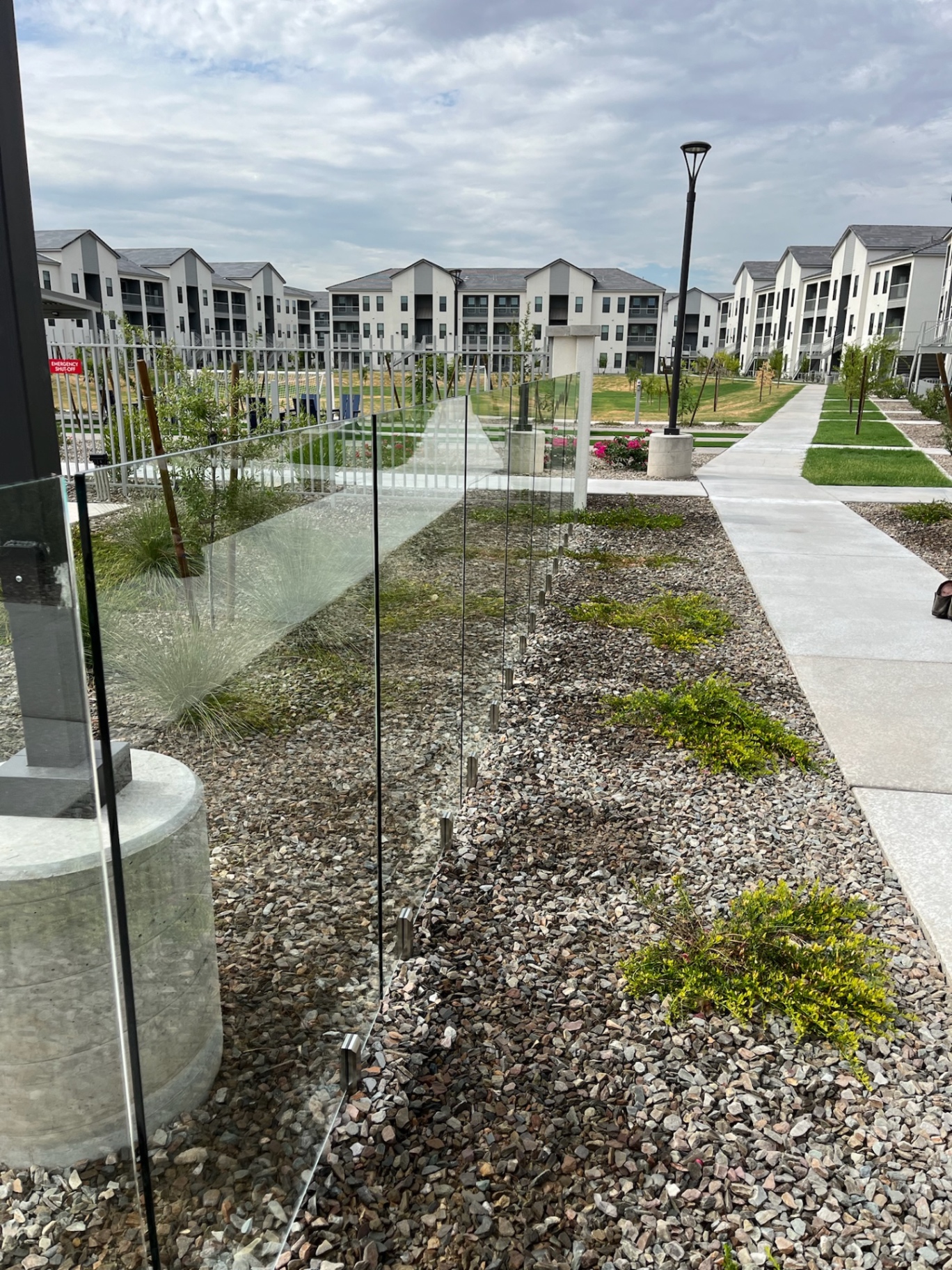 Commercial frameless glass fencing line protecting a multifamily pool area in Arizona while keeping clear sightlines across the amenity deck.
