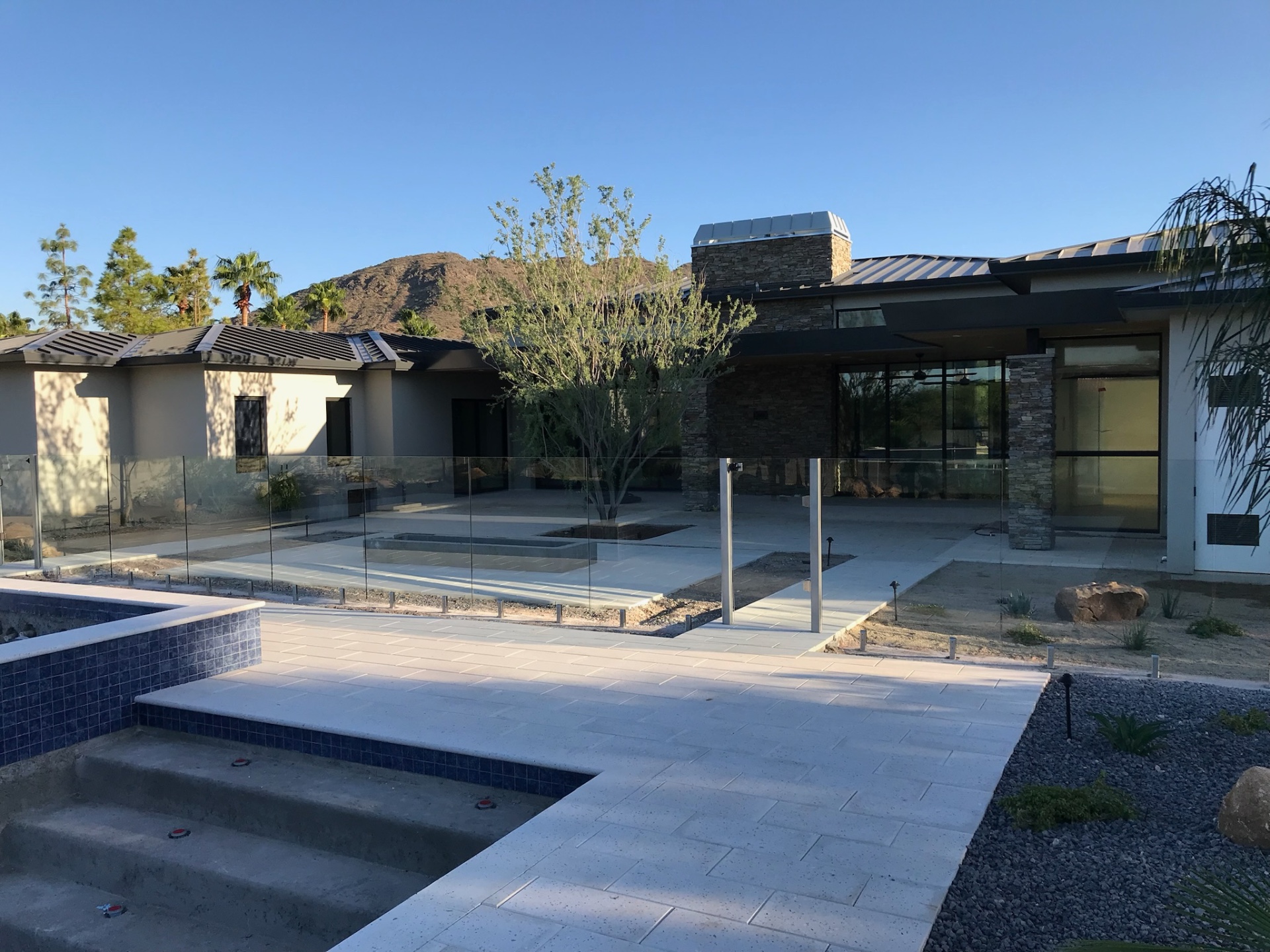 Frameless tempered glass pool fence at a modern Arizona desert estate installed by Sonoran Glass